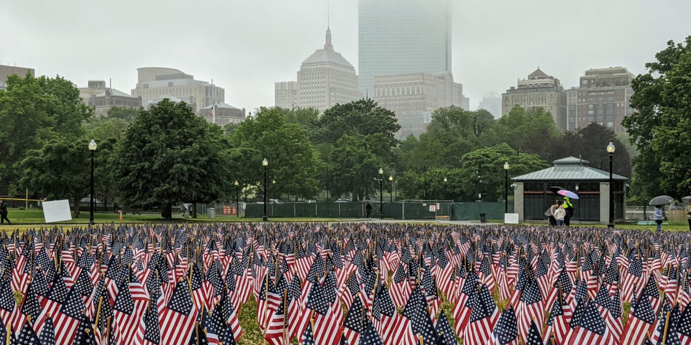 US flaglets at Boston Common with a foggy Boston urbanscape in the background
